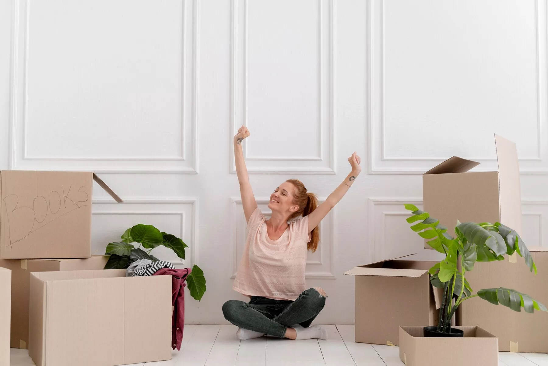 Happy woman with boxes moving house