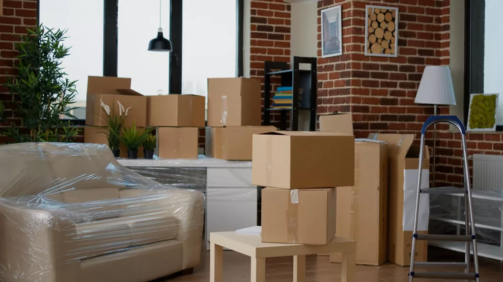 living room with cardboard packaging new home furniture things stack carton boxes no people household property with package cargo move real estate at Melbourne